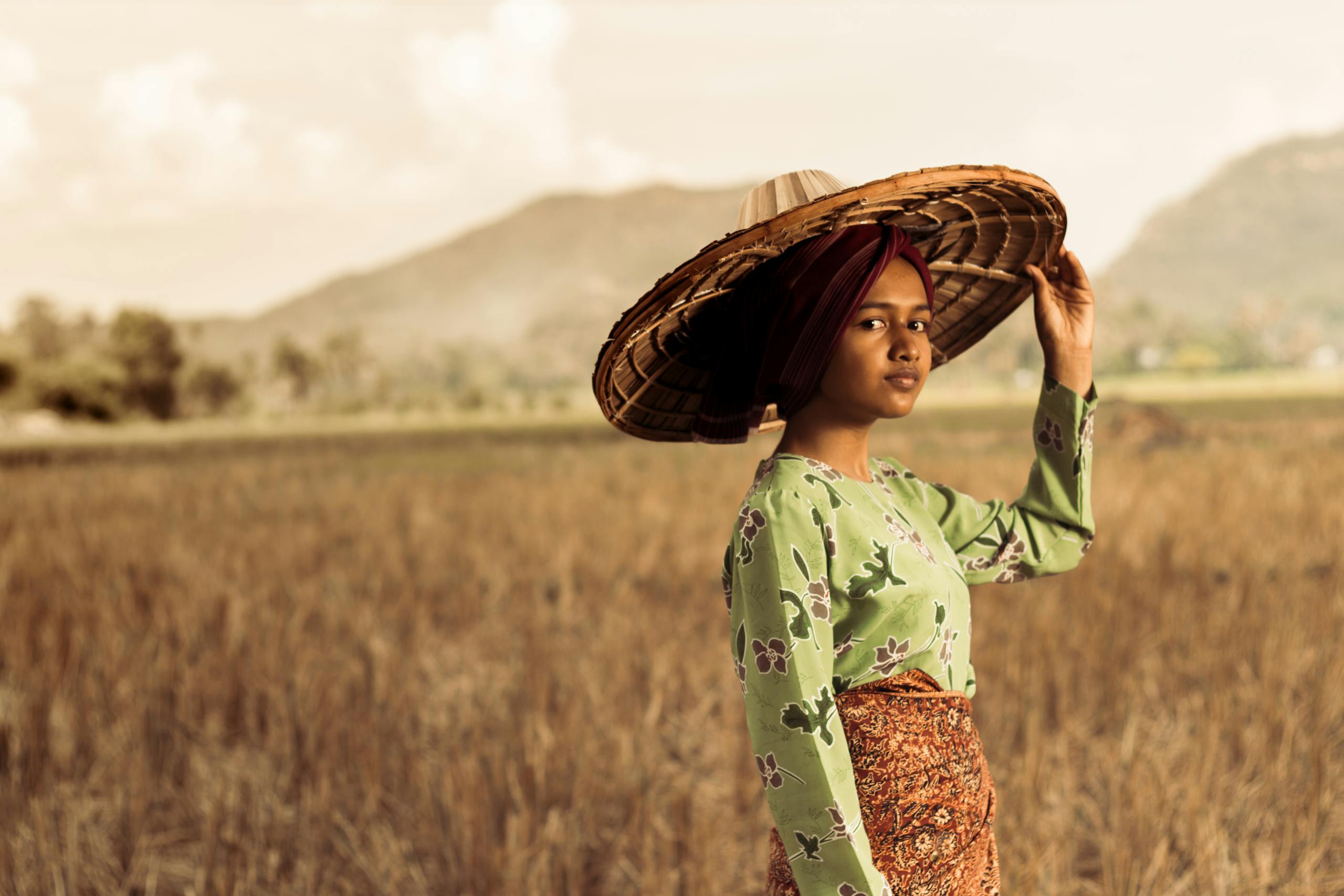 Photo of Woman Standing While Wearing Straw Hat